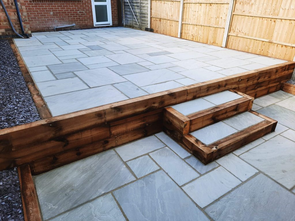 JD Landscapes Garden with Timber Sleeper Retaining Wall with Steps Natural Stone Slabs in Grey