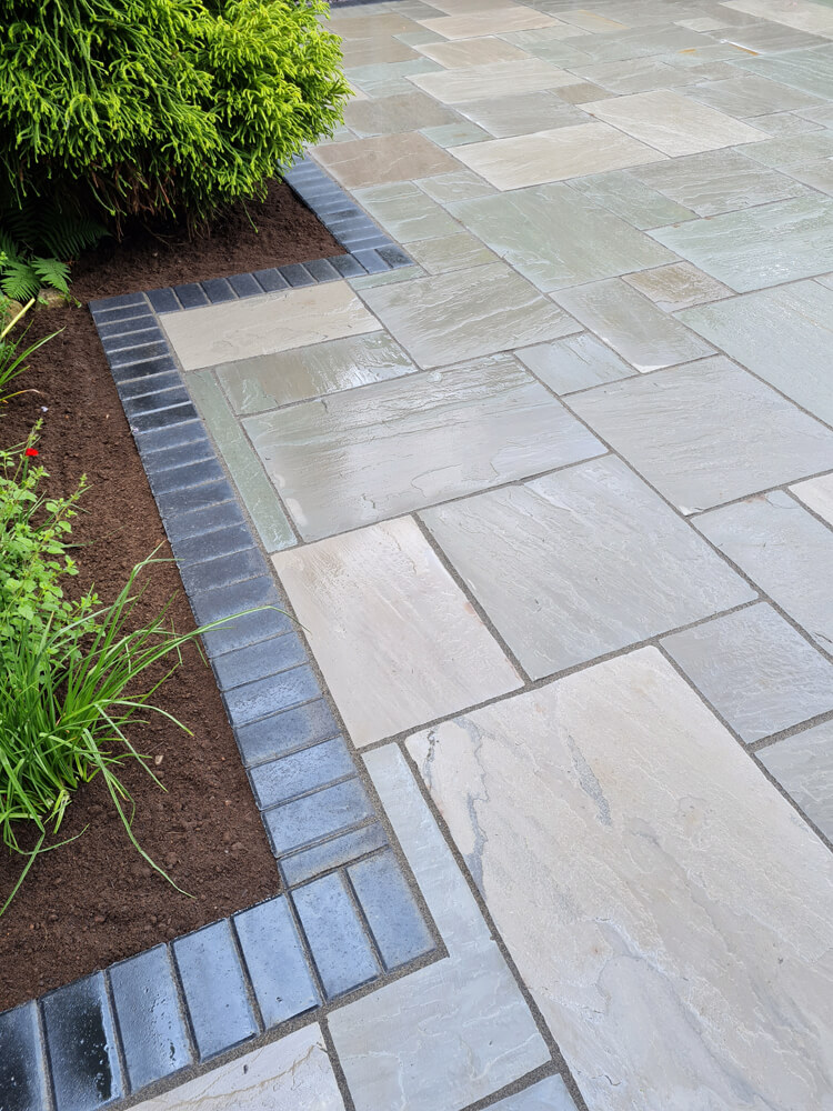 Case Study natural sandstone in grey slabs with charcoal block paving border