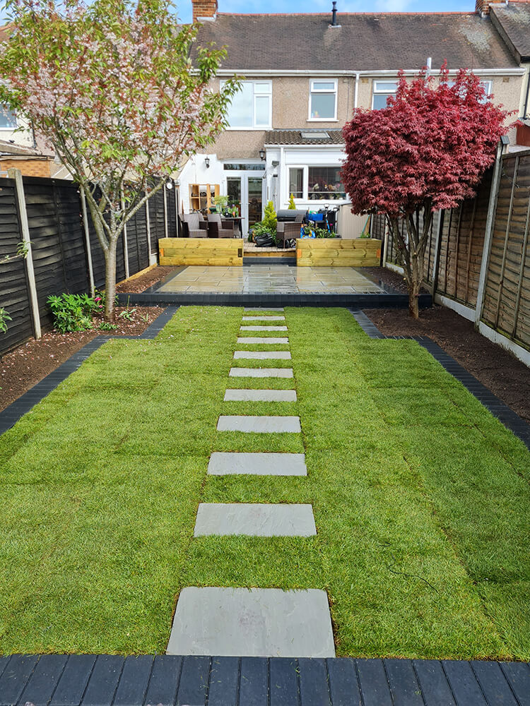 Case Study landscape garden transformation Coventry medallion turf with sandstone stepping stones after
